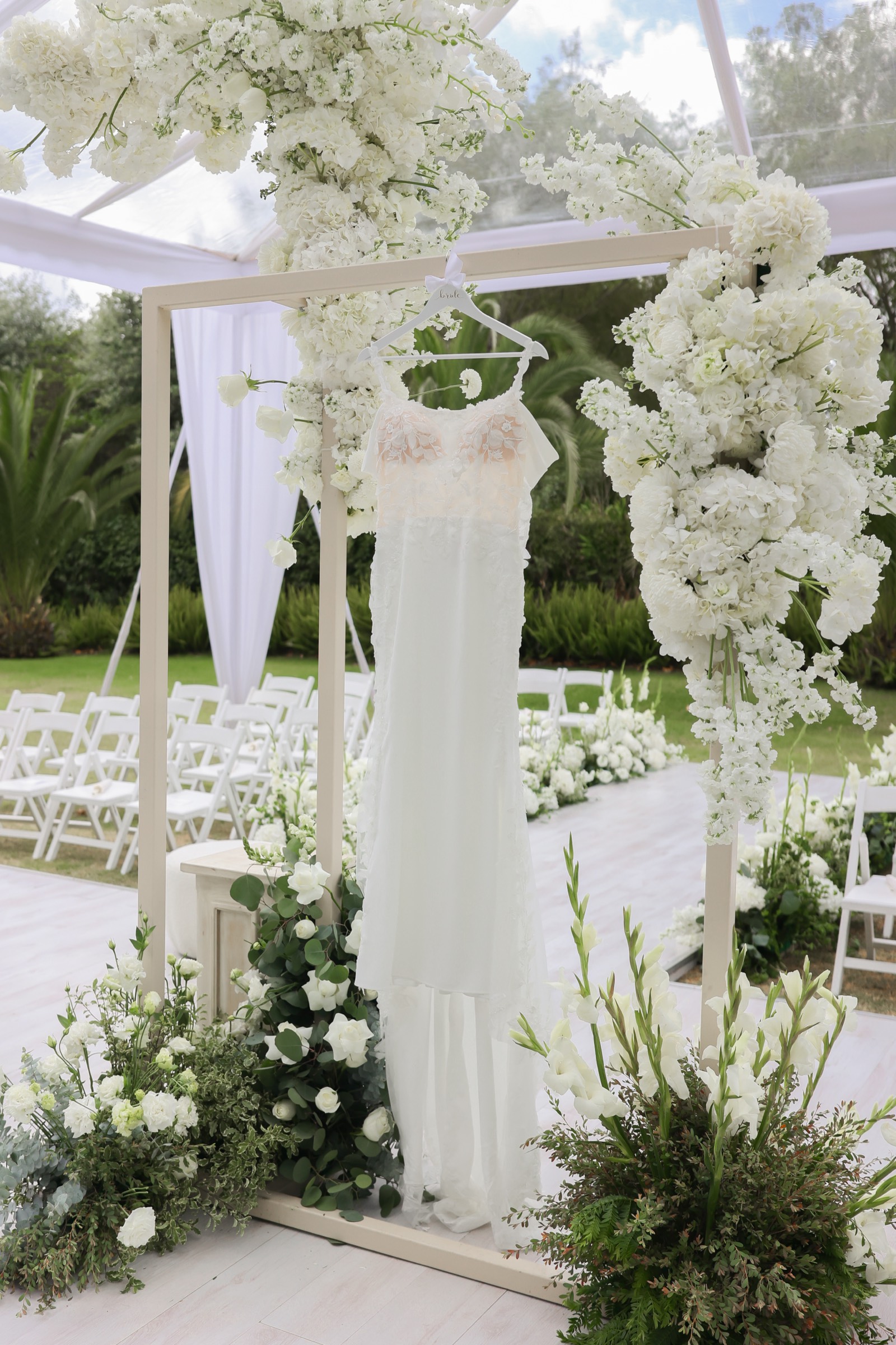 Arco de ceremonia con vestido de novia colgado
